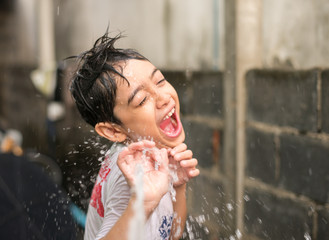 Little boy playing water splash
