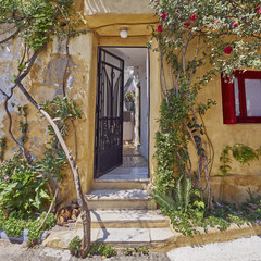Fototapeta na wymiar Athens Greece, house entrance at Anafiotika, an old neighborhood under acropolis, built by Anafi islanders according to their tradition around 1840