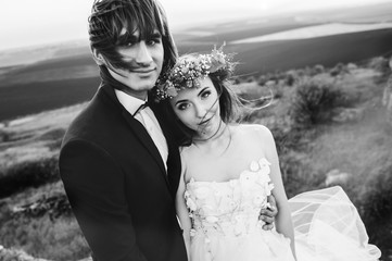 beautiful stylish groom holding fabulous happy emotional bride o