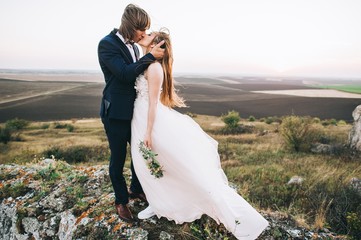 beautiful stylish groom holding fabulous happy emotional bride o