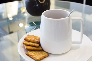 Coffee cup in coffee shop with snack