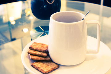 Coffee cup in coffee shop with snack