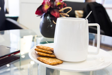 Coffee cup in coffee shop with snack