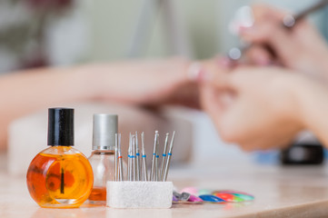 bottles and tools for manicure after work close-up in nail salon