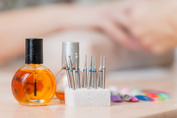 bottles and tools for manicure after work close-up in nail salon (Shallow DOF)