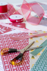 Vertical view of scissors and other props for wrapping christmas presents.