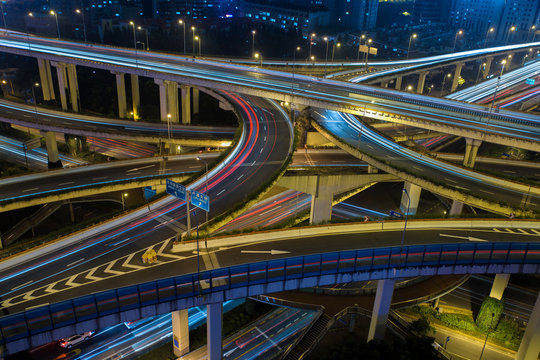 Modern city traffic road at night. Transport junction.