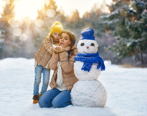 Mother and child girl on a winter walk