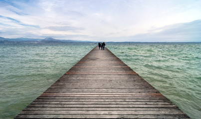 wooden pier and sky over Garda lake - Italy