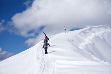 Fototapeta na wymiar Skiers climbing a snowy mountain