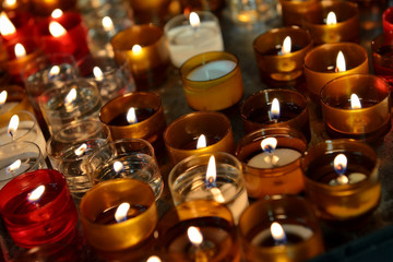 Firing church candles in dark interior