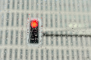 Traffic lights behind car window in rainy day - 96749094