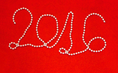 2016 New Year inscription made of white beaded necklace