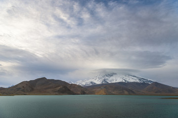 Landscape of Karakul lake, in Xinjiang province of China lies on the Karakoram Highway linking Kashgar in China with Islamabad in Pakistan. It's in the Pamir mountain range.