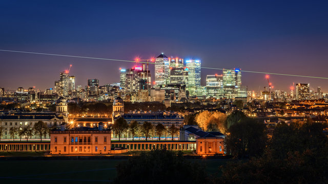 Night View To Greenwich, Prime Meridian Beam And Canary Wharf In