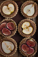 whole wheat tarts  with chocolate frangipane, figs, apple and pe