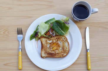 Breakfast fried egg on toast and green salad