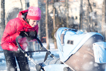 Young mother with baby in winter