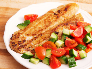 Fried white fish with salad
