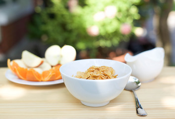 Bowl of honey-sugar corn flakes and spoon