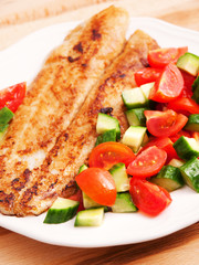 Fried white fish with salad