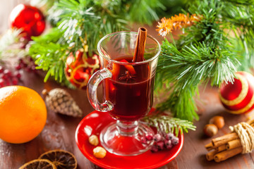 Fototapeta na wymiar Mulled wine with citrus fruits and cinnamon. Traditional winter hot drink for Christmas.