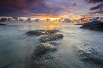 sunrise at rocky beach in terengganu, malaysia. image taken with