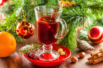 Fototapeta na wymiar Mulled wine with citrus fruits and cinnamon. Traditional winter hot drink for Christmas.