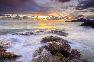 sunrise at rocky beach in terengganu, malaysia. image taken with