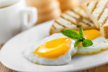 Fototapeta premium Fried eggs with coffee served for breakfast. Traditional healthy food.