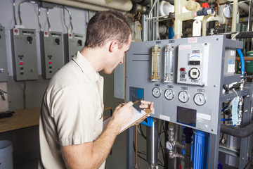 Technician inspecting heating system in boiler room