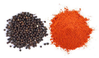 Powdered dried red pepper and peppercorn on white background