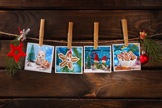 four christmas cards hanging on rope against wooden background