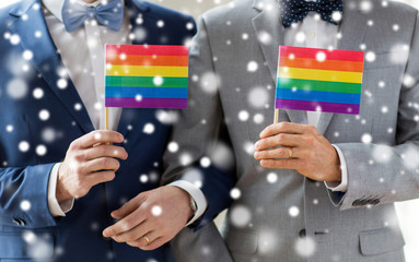 Fototapeta na wymiar close up of male gay couple holding rainbow flags