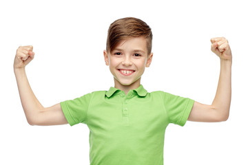 happy boy in polo t-shirt showing strong fists