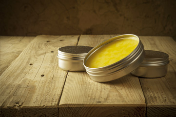 Open glass pot with honey moisturizer isolated 