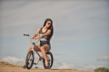 Beautiful young girl on a bicycle BMX