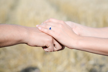 Female's hands put over the male's hand