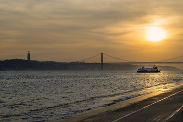 View of the bridge over the Tagus River (25 de Abril bridge) in Lisbon, Portugal, at sunset