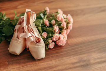 bouquet of pink roses and pointe shoes