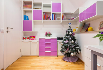 Interior of a teenage girl room with decorated Christmas tree