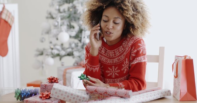 Young woman chatting on her mobile at Christmas