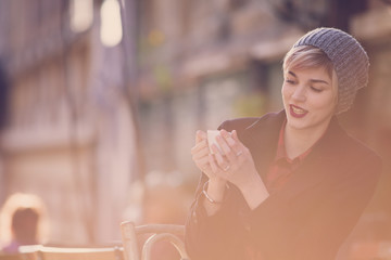 Young beautiful woman drinking coffee at cafe