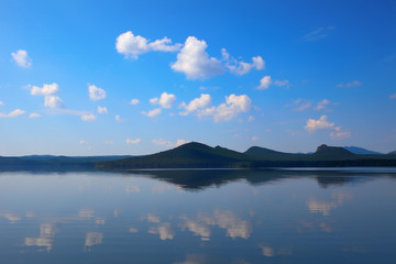 Untouched nature. View the sky with clouds and their reflection