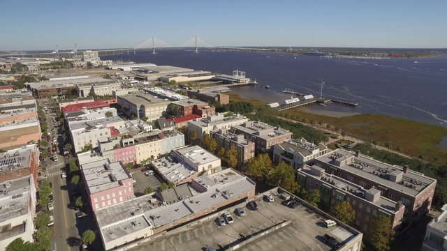 An aerial establishing shot of Charleston, South Carolina. The Arthur Ravenel Bridge is seen in the background.	