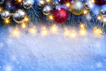 art Christmas background with a christmas ornament and fir in sn