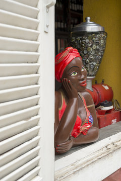 Smiling Brazilian woman colorful namoradeira figurine in the window in the Santa Teresa neighborhood of Rio de Janeiro, Brazil