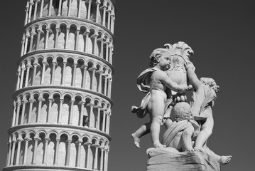 Leaning Tower of Pisa with a statue in foreground