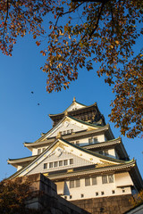 Osaka Castle, the historical Osaka Castle in spring season colouring red tree surrounding