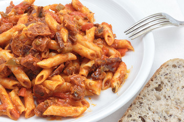 Macaroni with tomato sauce, sausage and pepper.